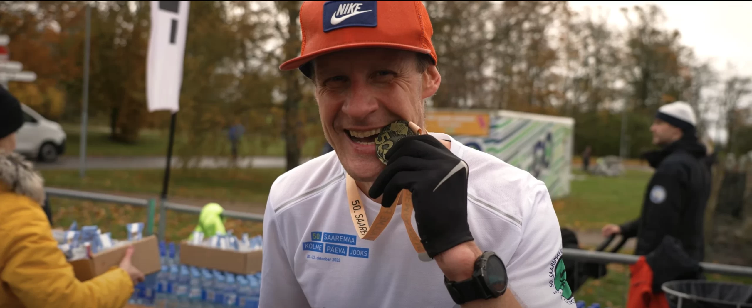 A champion biting his custom-designed race medal.