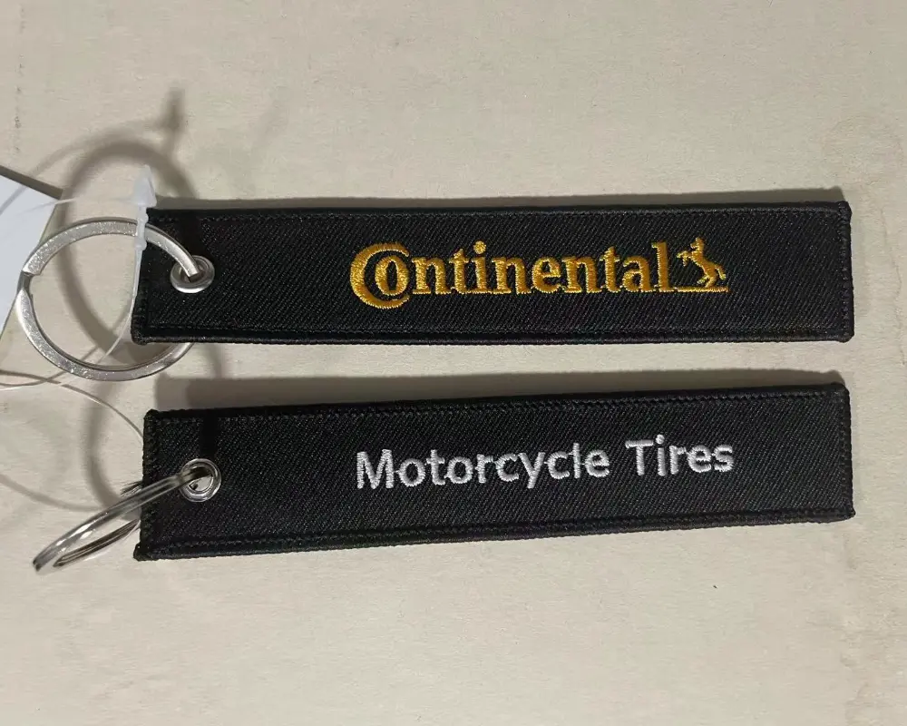Two complete Continental fabric keychains showcasing detailed embroidery.