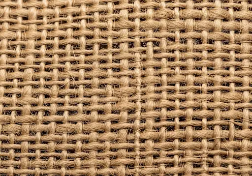 A swatch of natural, unlaminated jute fabric, also known as burlap.