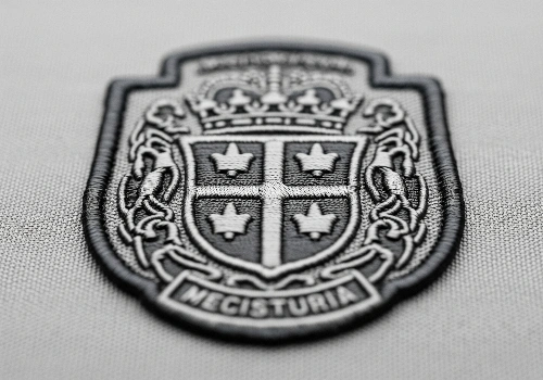 A close-up of a custom woven keychains, highlighting its flat, smooth surface and intricate detail.