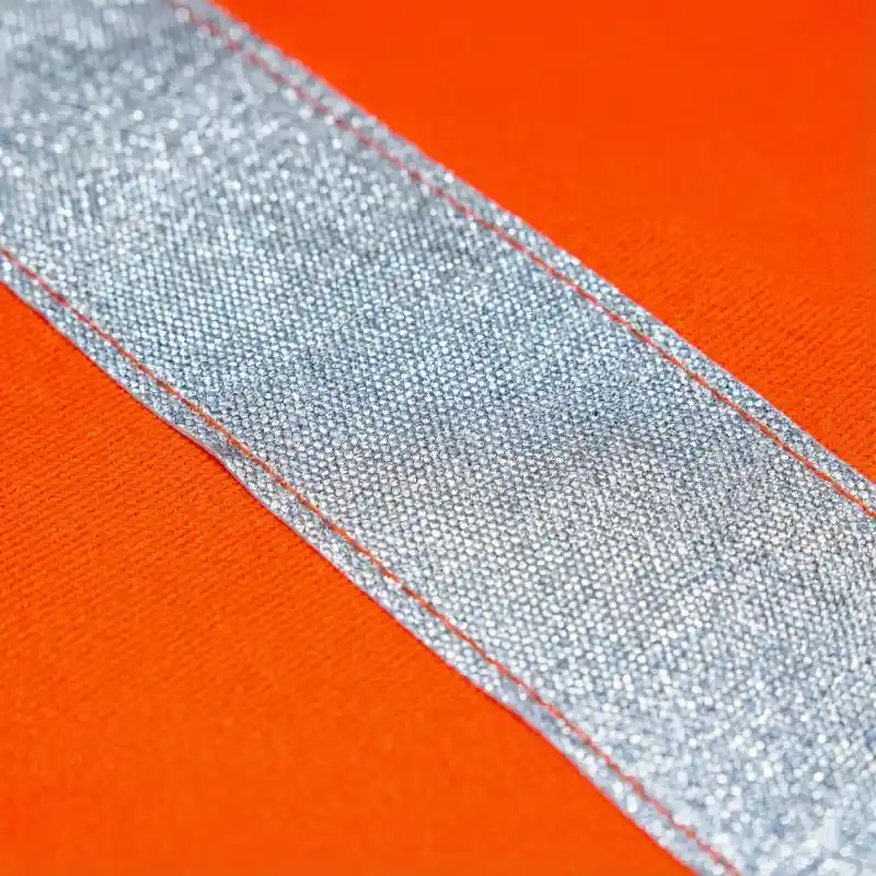 Close up of silver reflective strip heat-transferred onto neon fabric.