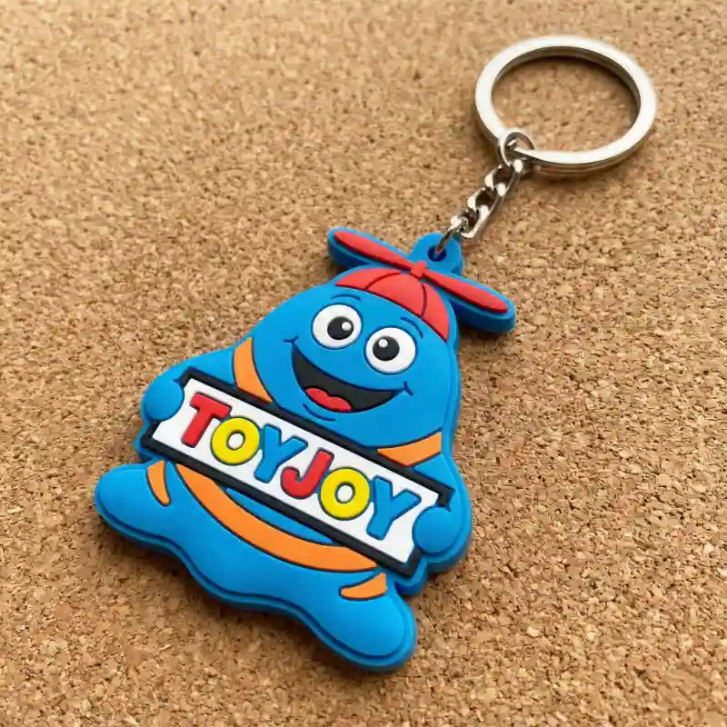 Colorful soft PVC rubber keychain featuring a brand mascot in a custom 3D shape.
