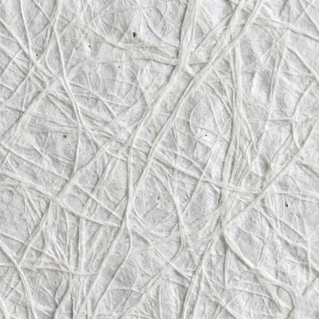Macro shot of white Tyvek material showing the fibrous, paper-like texture.