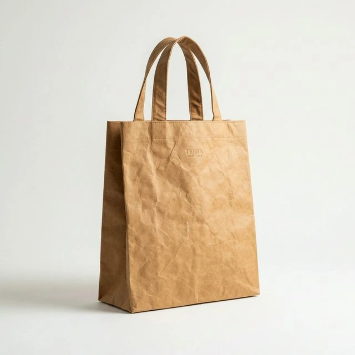 Premium tan washable kraft paper tote bag standing upright.