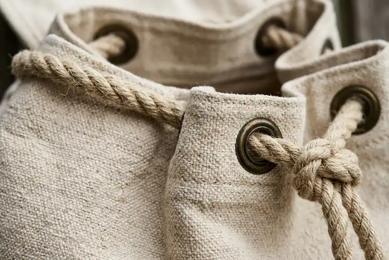 Heavy duty natural cotton canvas rucksack showing sturdy organic weave and thick rope drawstrings.