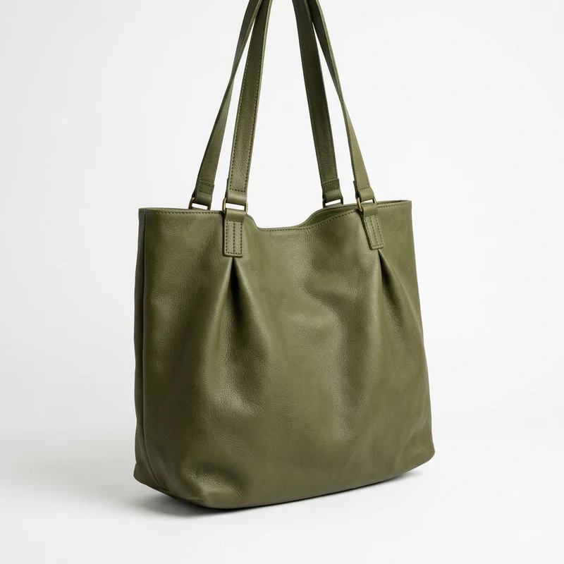 Minimalist slouchy olive green cactus leather tote bag hanging.
